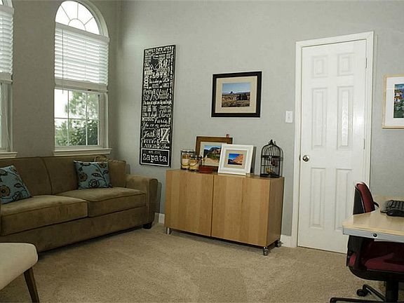 The study / 4th bedroom located off the entry. High ceiling and arched windows. The home also offers