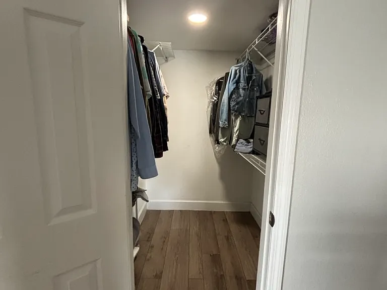 Walk in closet with built in shelving and plenty storage