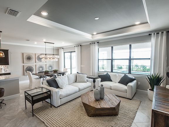 Model Representation Open gathering room, kitchen dining spaces with connected tile flooring