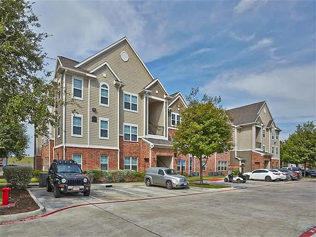 Exterior of apartment building with open lot parking