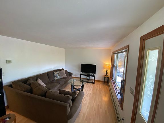 Entry to unit and living room. Sofa, lamps, small table, and TV with stand included with furniture.