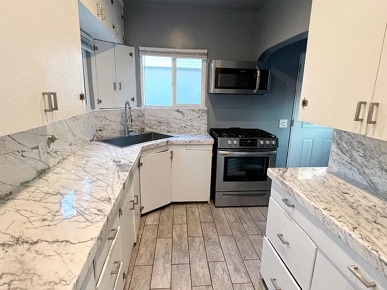 Kitchen area and entrance to courtyard heading left in laundry area/laundry attachment