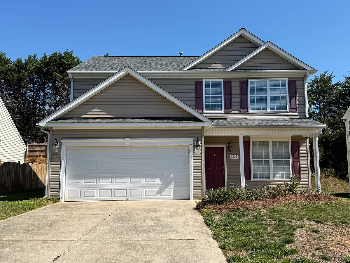 Another front view of this home that features a front entry garage, covered front porch, and energy efficient windows. The front yard will be landscaped with a landscaped island (owner had 2 front trees removed) - 6522 Overland Park Dr