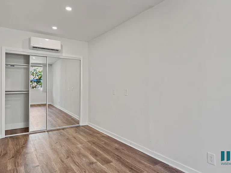 Bedroom with Mirrored Closet, Vinyl Flooring, and Recessed Lighting