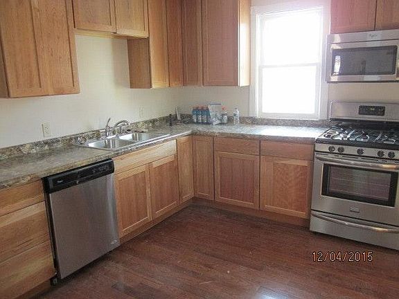 kitchen with cherry cabinets, dishwasher, five burner stove and above range microwave