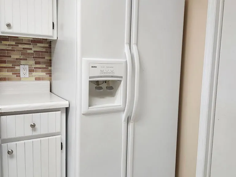 Refrigerator/Freezer with Ice/water dispenser(vent cover IS included. Was off for cleaning in pic).
