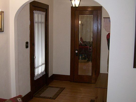 Front Entry with spacious closet behind vintage oak mirrored door.