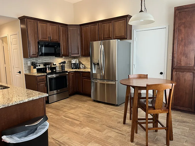 Updated kitchen with granite countertops, stainless steel appliances, and custom cabinetry.