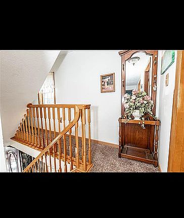 Hallway leading to walk in attic