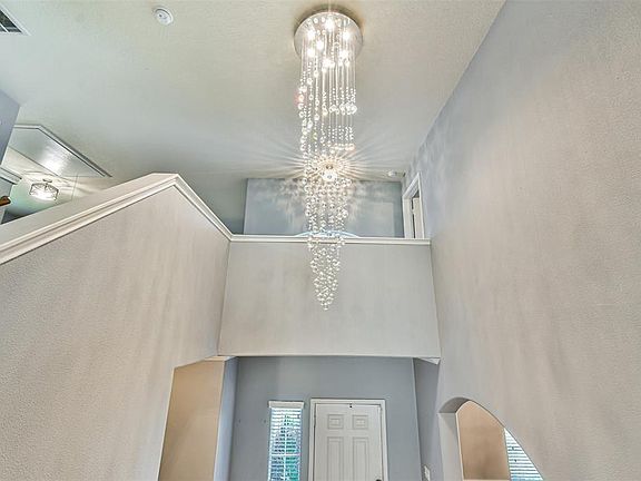 A beautiful chandelier in the foyer as you enter your home.