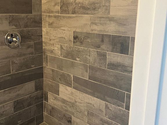 Chester B's new tile shower is located within the Jack- N- Jill Bathroom between the two bedrooms.