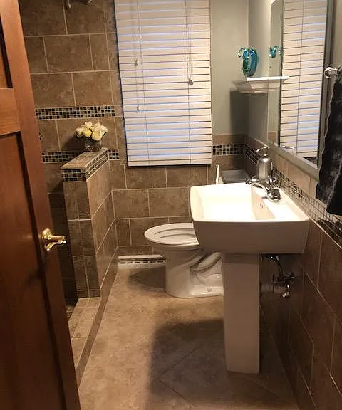 fully tiled bathroom on main level