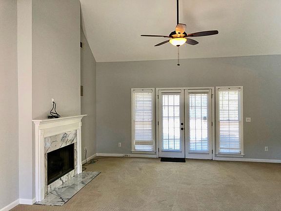 Vaulted ceiling in living room, with French doors leading ou