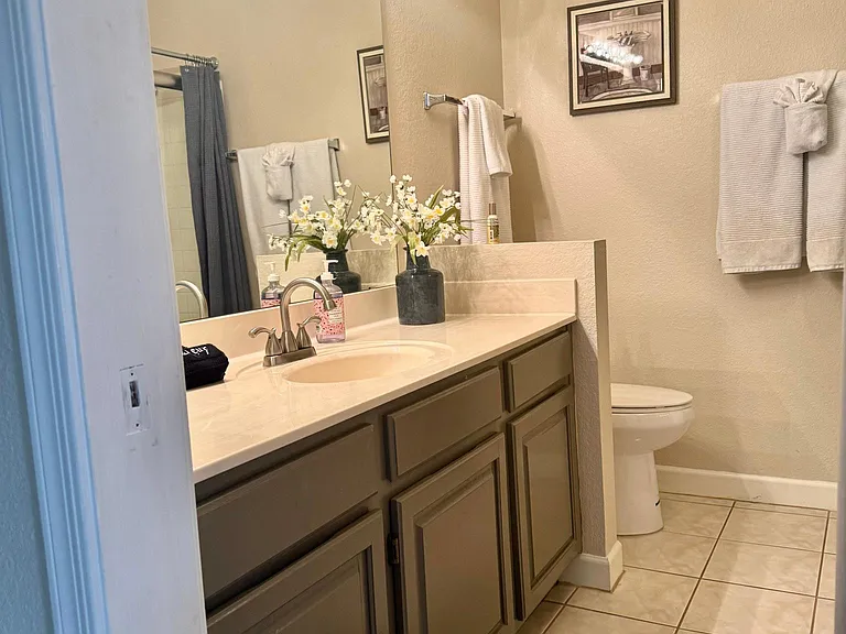 Second bathroom with full size stacked washer dryer