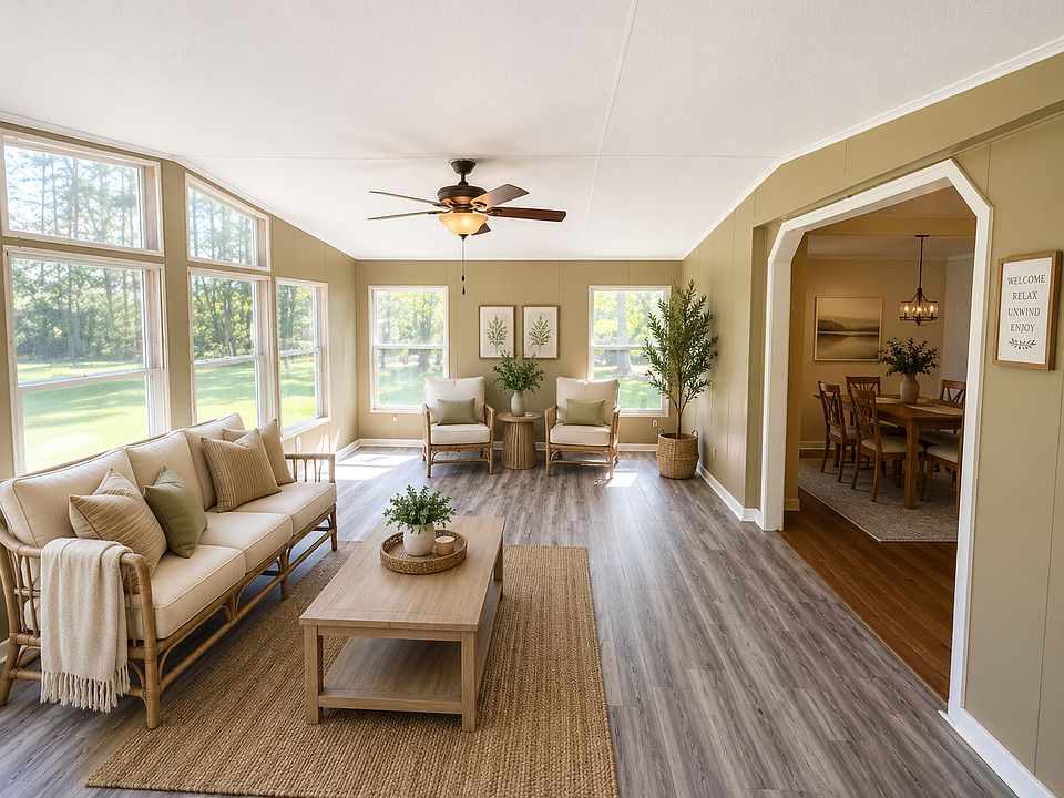 Expansive sunroom with backyard views, sliding glass doors to the back deck, and direct access to the dining room.