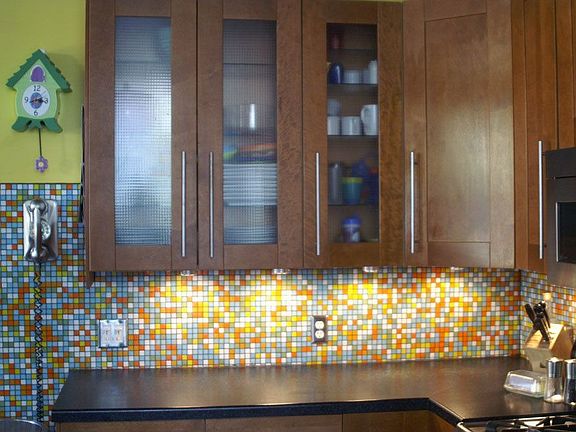 Glass tile backsplash / Lighting in cabinets with dimmer controls.
