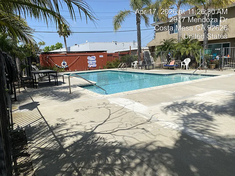 Gated swimming pool with concrete decking
