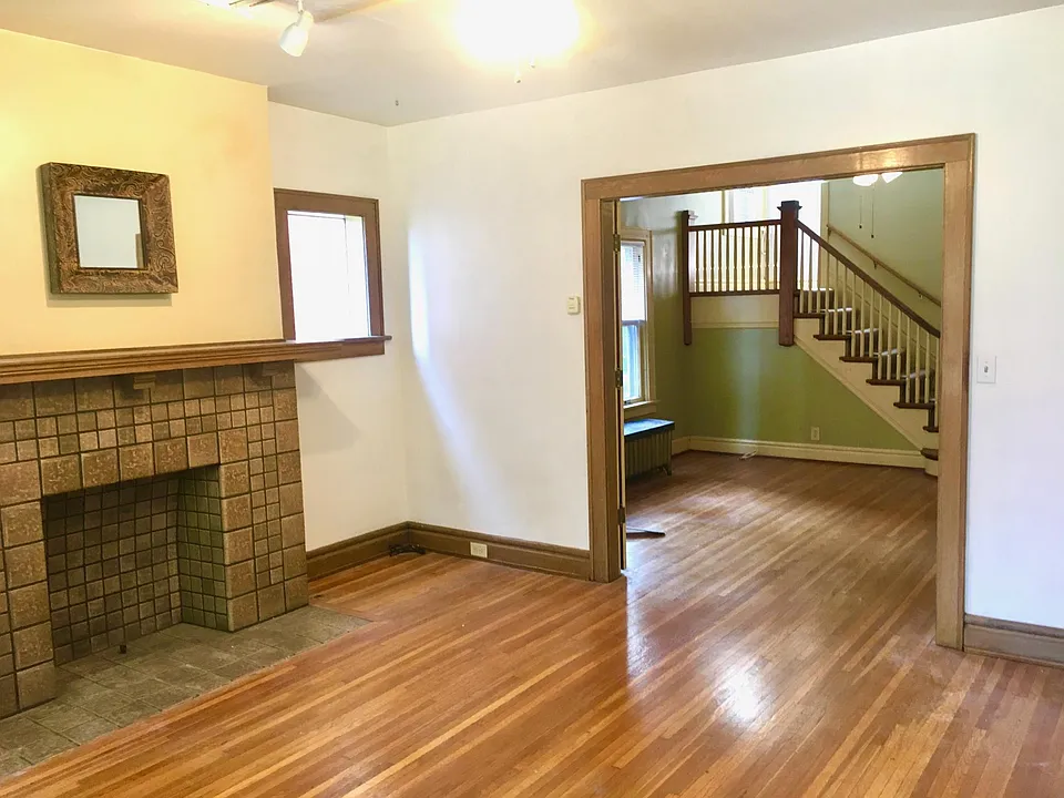 View from living room towards dining room, stairs, and kitchen.