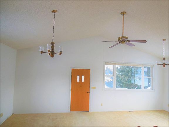 Open Air Living Room with peaked ceiling, large windows over