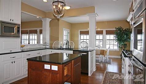Open and inviting Kitchen with stainless steel appliances, island, breakfast area, 5 burner gas stov