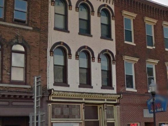 Store below apartment in historic building (1868) has original leaded glass