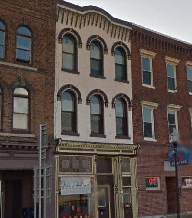 Store below apartment in historic building (1868) has original leaded glass
