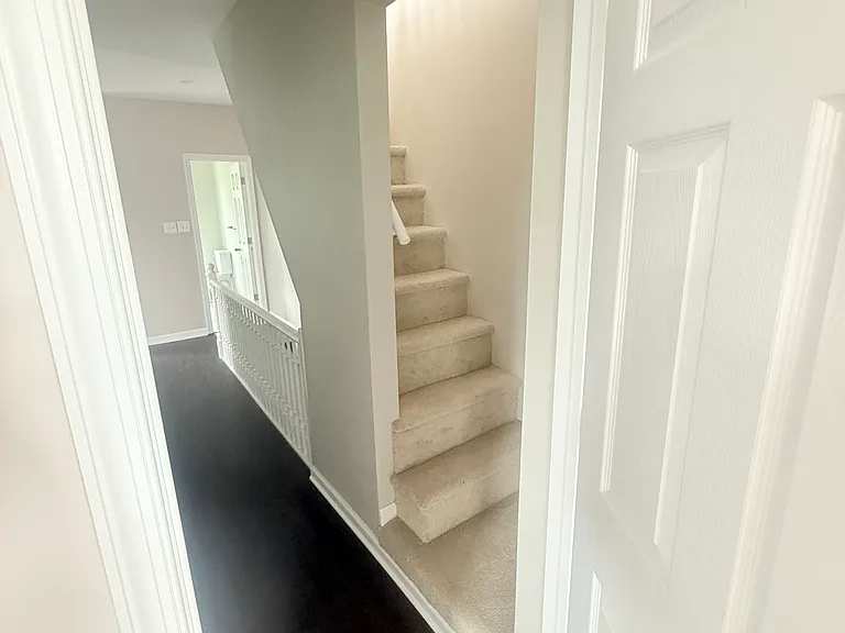 1st Bedroom Looking at Second Floor Hallway and Staircase to Third Floor