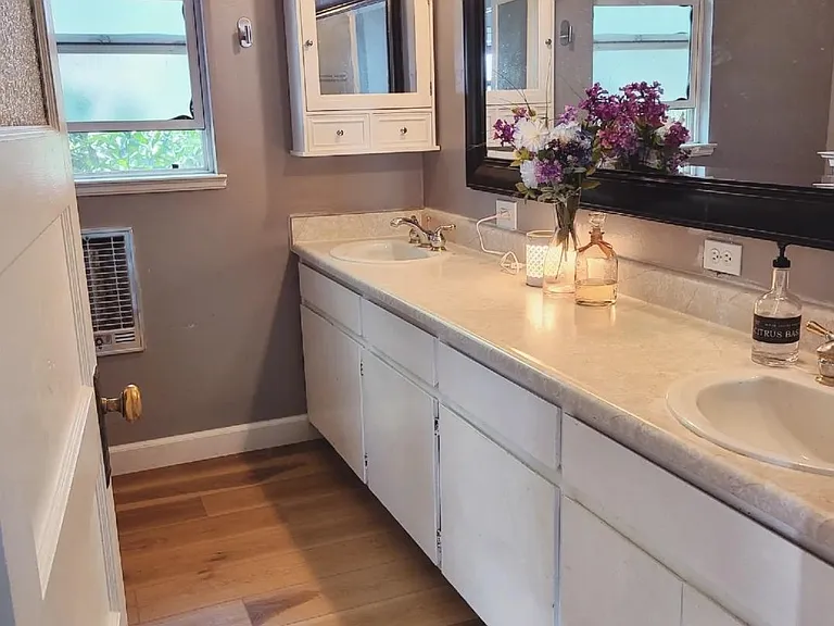 Large main bathroom with double sinks and an original claw foot tub (with shower combo). Newly installed luxury vinyl waterproof flooring.
