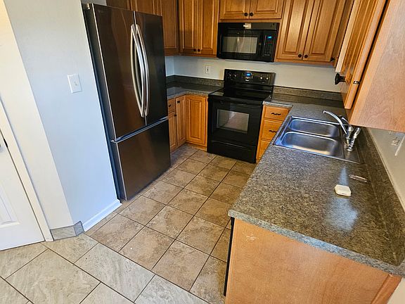 Kitchen with stainless counter depth refrigerator