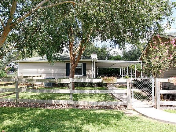 Side view near driveway showing  fence. This home offers a ton of privacy!