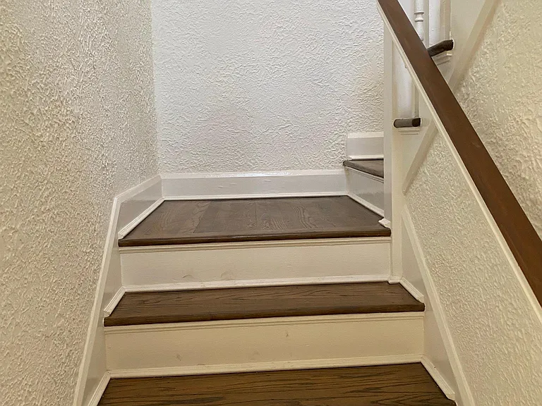 Newly refinished stairs and banisters 
restored to original form