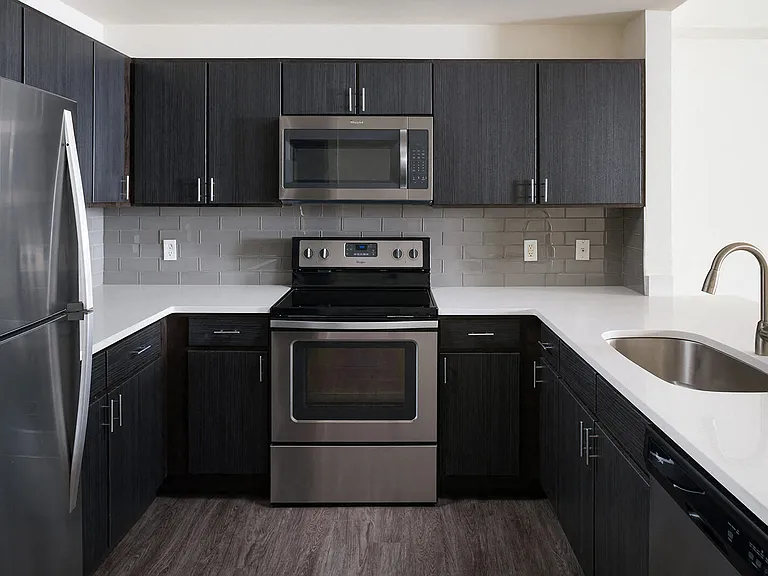Whip up your favorite meals in a kitchen with stylish espresso cabinetry and bright white countertops.