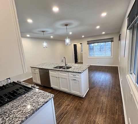 Kitchen, island, and living room. Great lighting with living room, pendent, and kitchen lights on separate 3-way dimmers plus under cabinet/stove lighting. Kitchen island includes dishwasher, sink, garbage and recycling drawer, and garbage disposal.