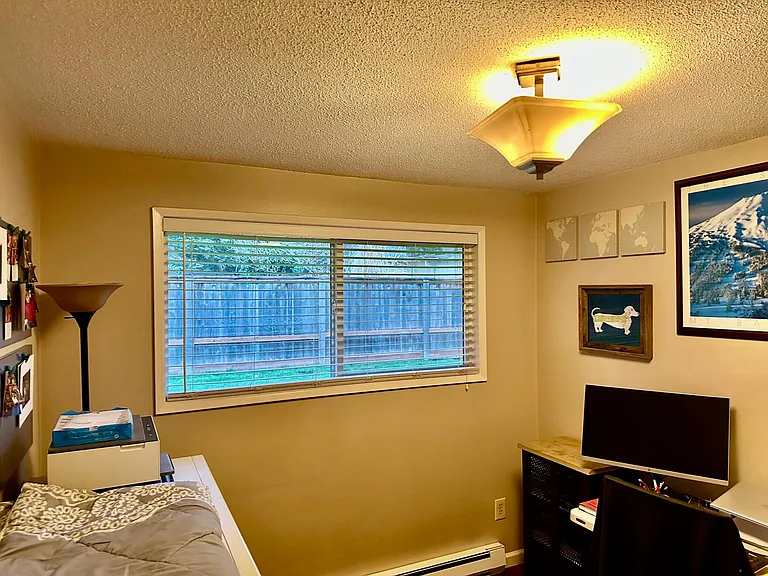 Smaller of the two bedrooms with view of backyard.