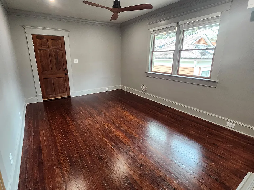 Enter into the large living room featuring heart of pine floors.