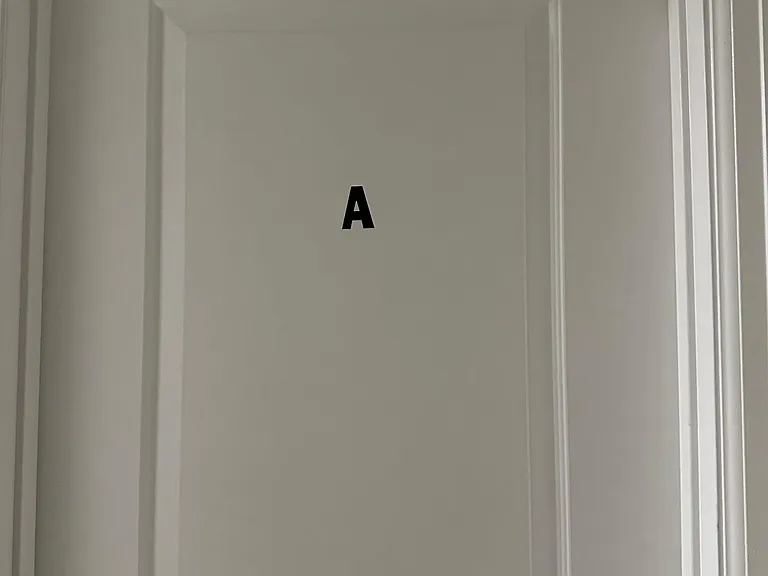 Interior doorway with clean trim and a labeled door, providing easy room identification and access within the home.