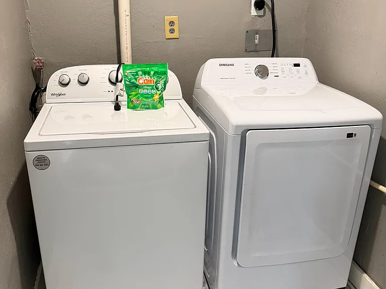 Dedicated laundry nook with a full-size washer and dryer for convenient in-home laundry day routines.
