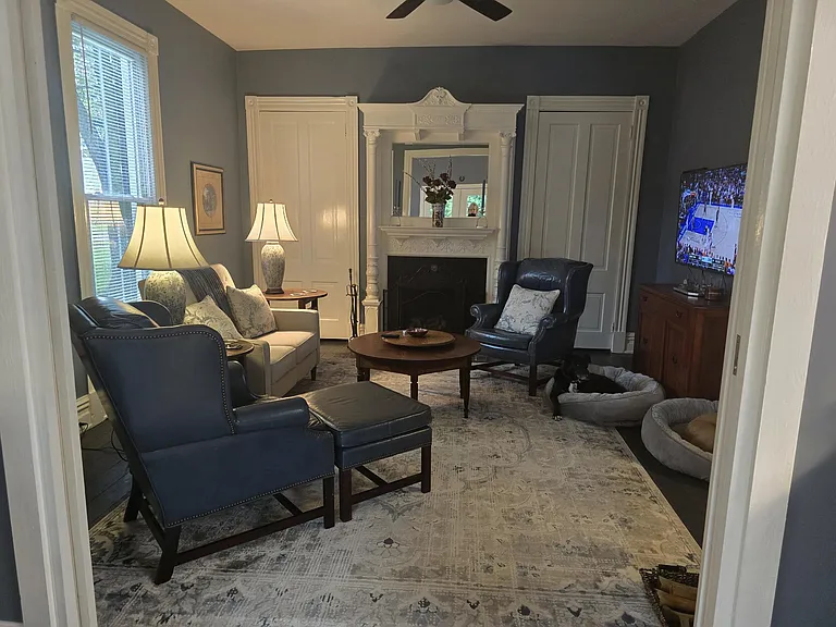 Living area with ample closets. Period mantle; leather chairs and reclining love seat. Pocket door separates living area from Keeping Room/area for privacy. Ceiling fan.