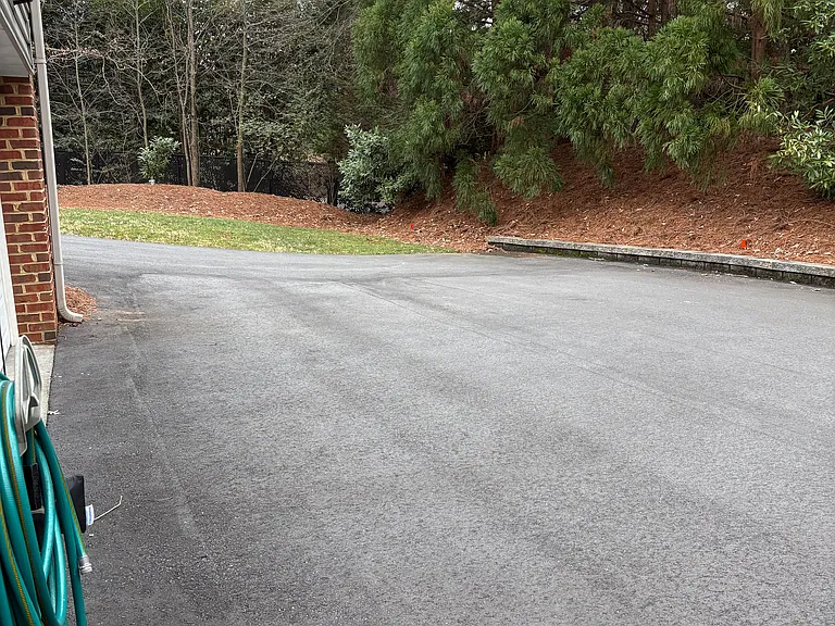 Parking area behind the house going in to the garage/basement