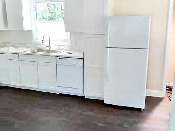 Kitchen shows new laminate flooring.