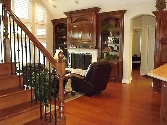 Great room with gorgeous custom cabinetry, wood burning fireplace and amazing views of the acreage.