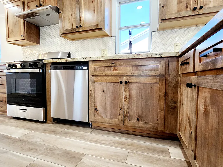 New custom kitchen with custom fabricated cabinets/ new custom granite countertops/new hardware/new stainless steel appliances/ new LVT flooring