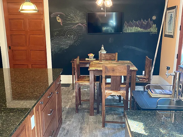 Kitchen/dining chalkboard wall and TV.