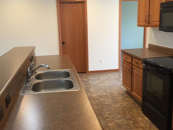 View of kitchen galley with view of front office or bedroom.