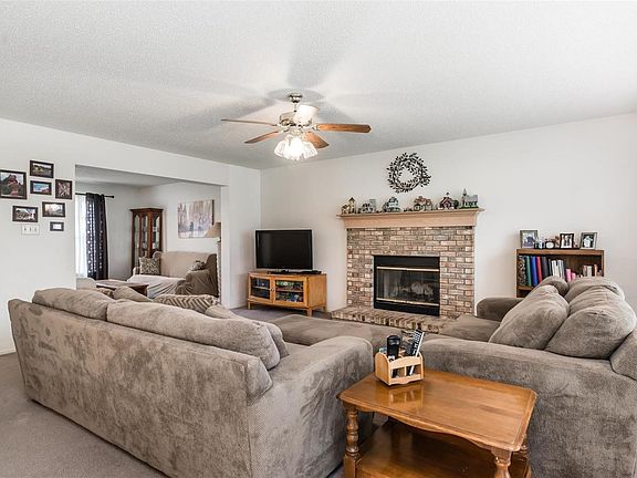 Family room w/ wood burning fireplace.