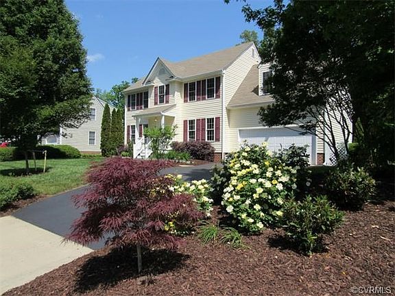 Professional landscaping and freshly sealed driveway