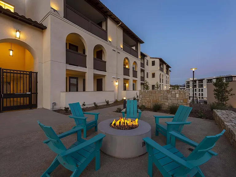 Enjoy warmth and ambiance by the fire pit, with inviting outdoor seating for a perfect night under the stars.
