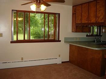 There is a good sized Dining Area off of the Kitchen and quite close to the Living Room. A table has great space when needed to be extended. Large window that over-looks the back yard. Ceiling Fan in this area also.