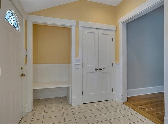 Custom built in bench and closet, a very welcoming entry.
