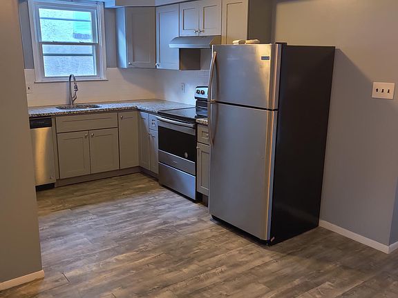 Kitchen with granite counters, subway tile backsplash, electric cooking, stainless steel appliances.